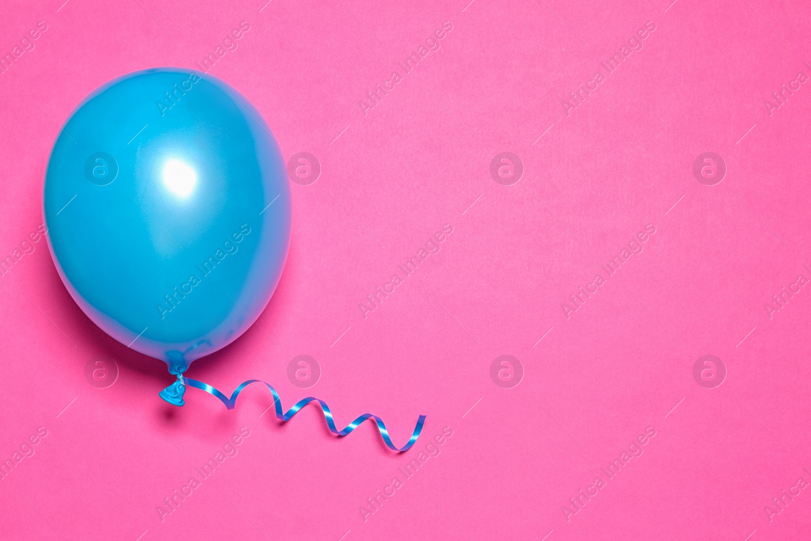 Photo of Bright balloon on color background, top view with space for text. Party time