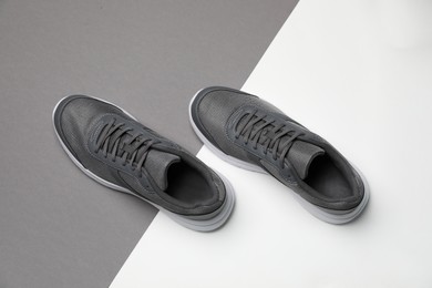 Photo of Pair of stylish sport shoes on color background, flat lay