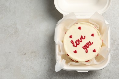 Photo of Bento cake with Love You text in takeaway box on light grey table, top view. Space for text. St. Valentine's day surprise