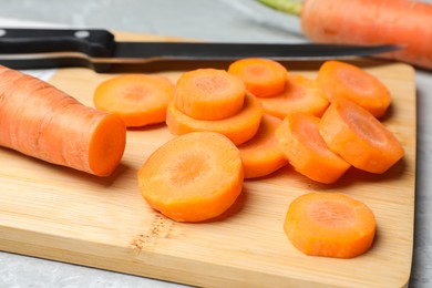 Photo of Sliced fresh ripe juicy carrots on table, closeup