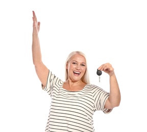 Happy mature woman with car key on white background. Getting driving license