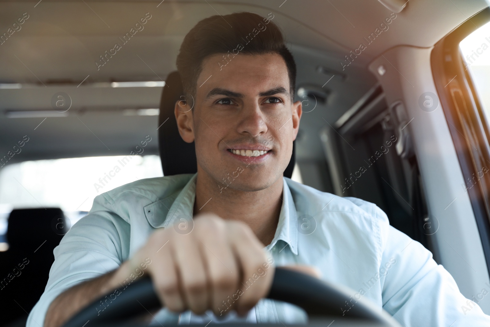 Photo of Handsome man driving his new modern car