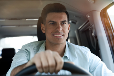 Photo of Handsome man driving his new modern car