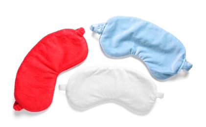 Photo of Three soft sleep masks isolated on white, top view