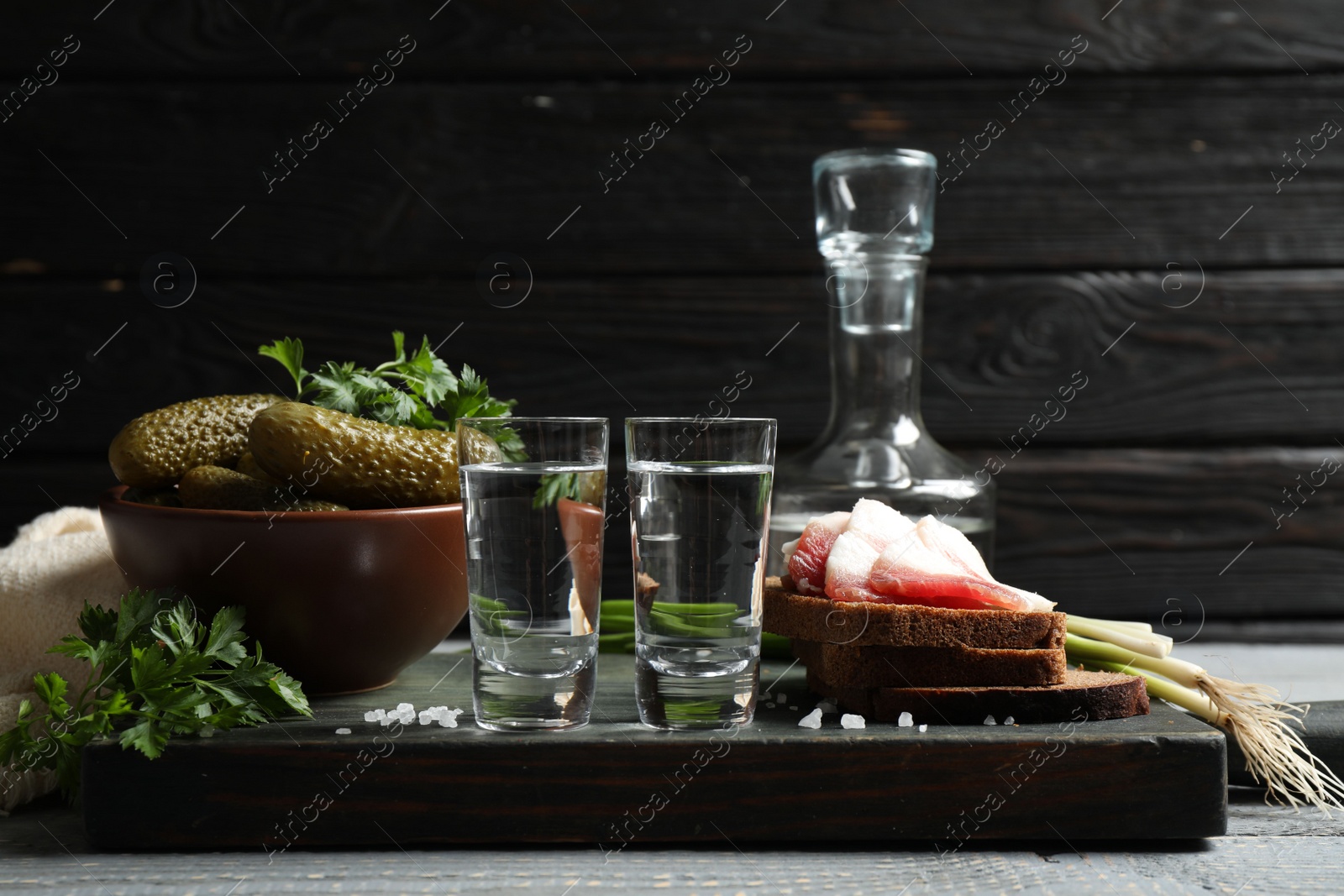 Photo of Cold Russian vodka with snacks on wooden table