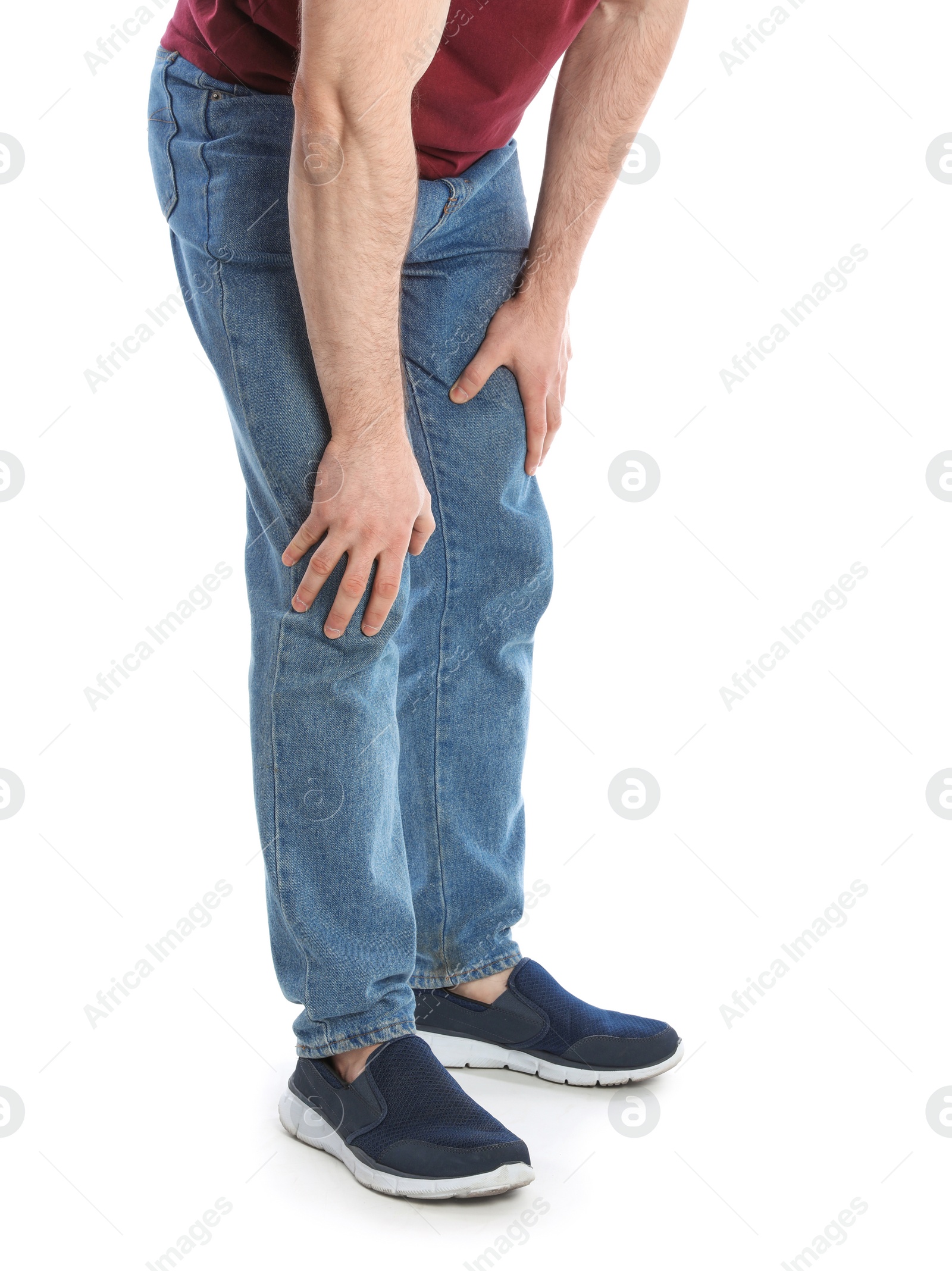 Photo of Young man suffering from leg pain on white background, closeup