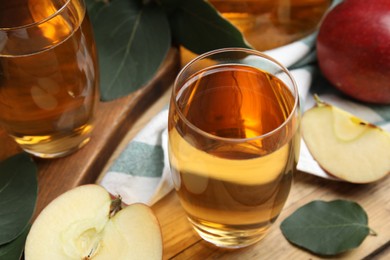 Delicious cider and ripe apples on wooden table