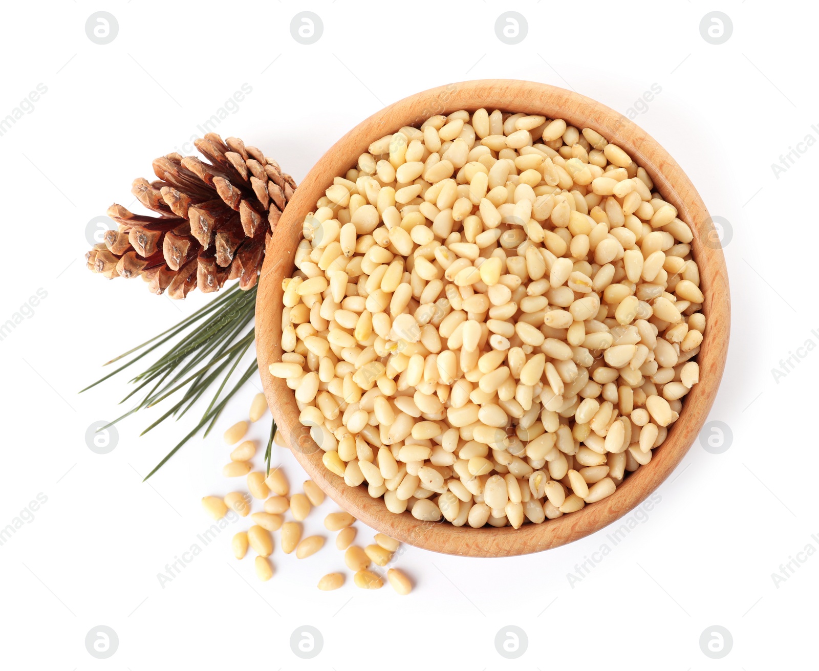 Photo of Bowl with pine nuts and cone on white background, top view