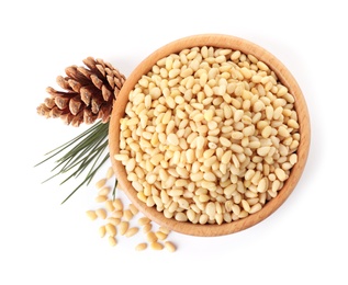 Bowl with pine nuts and cone on white background, top view