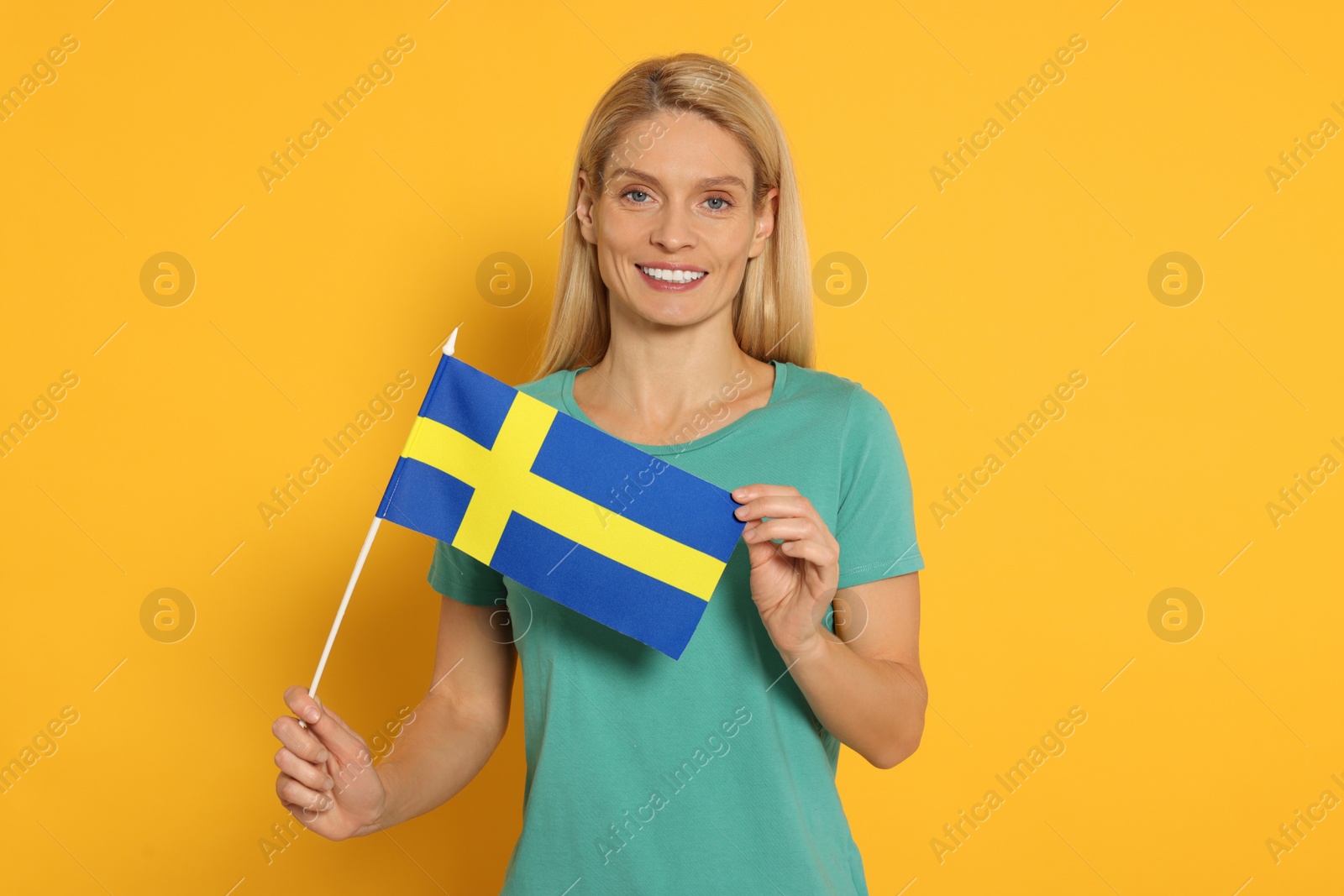 Photo of Woman with flag of Sweden on yellow background