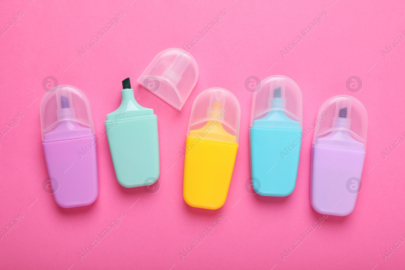 Photo of Many colorful markers on pink background, flat lay