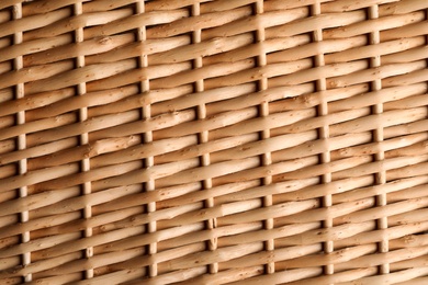 Photo of Handmade wicker basket made of natural material as background, closeup view