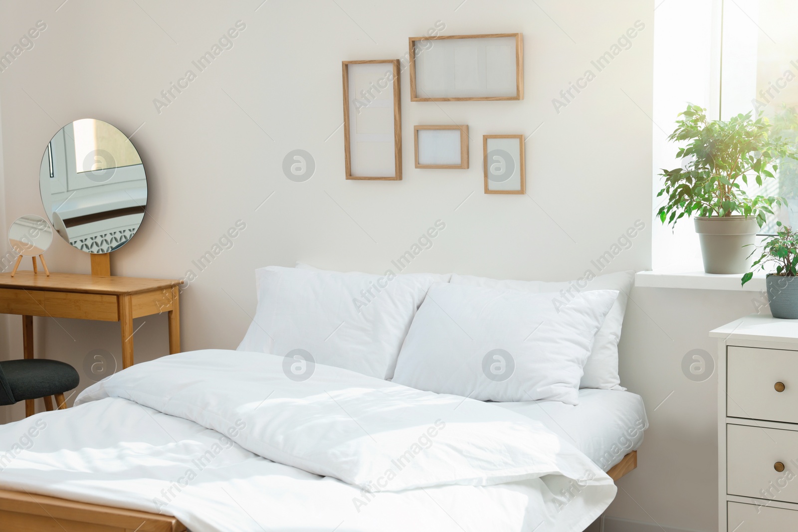 Photo of Bed with soft white pillows in cozy room interior