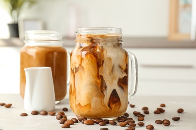 Mason jar with cold brew coffee on table