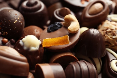 Photo of Different tasty chocolate candies, closeup