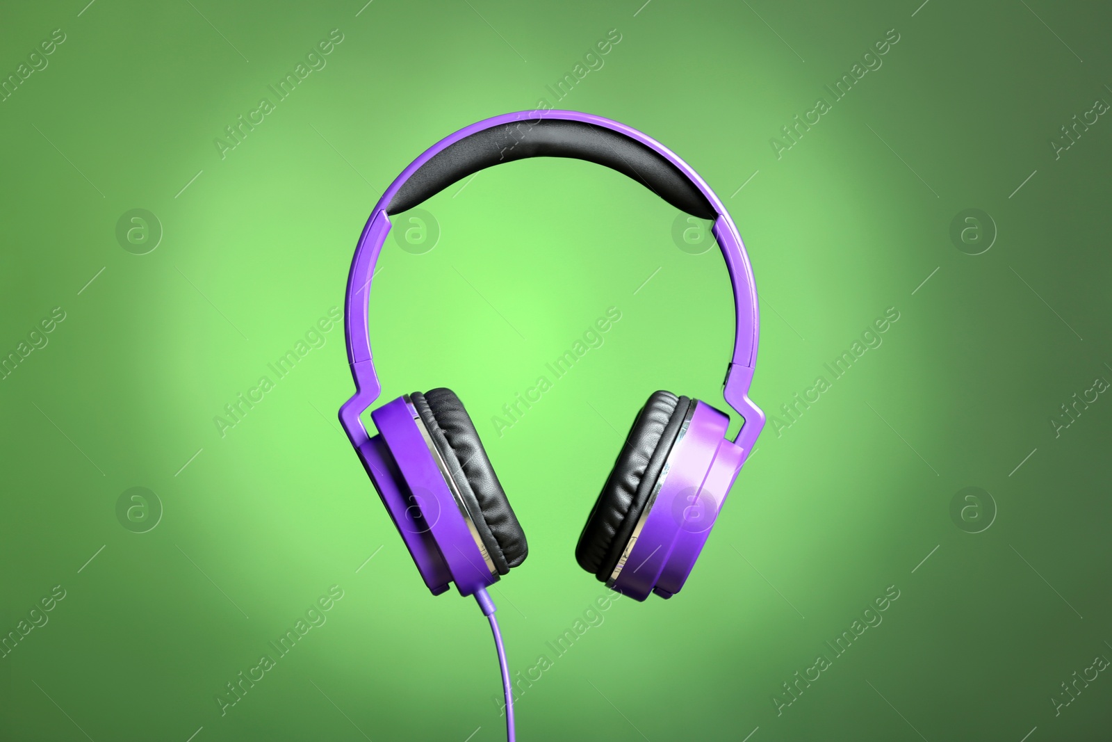 Photo of Stylish headphones with pads on color background