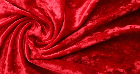 Photo of Texture of crumpled red velvet fabric as background, top view