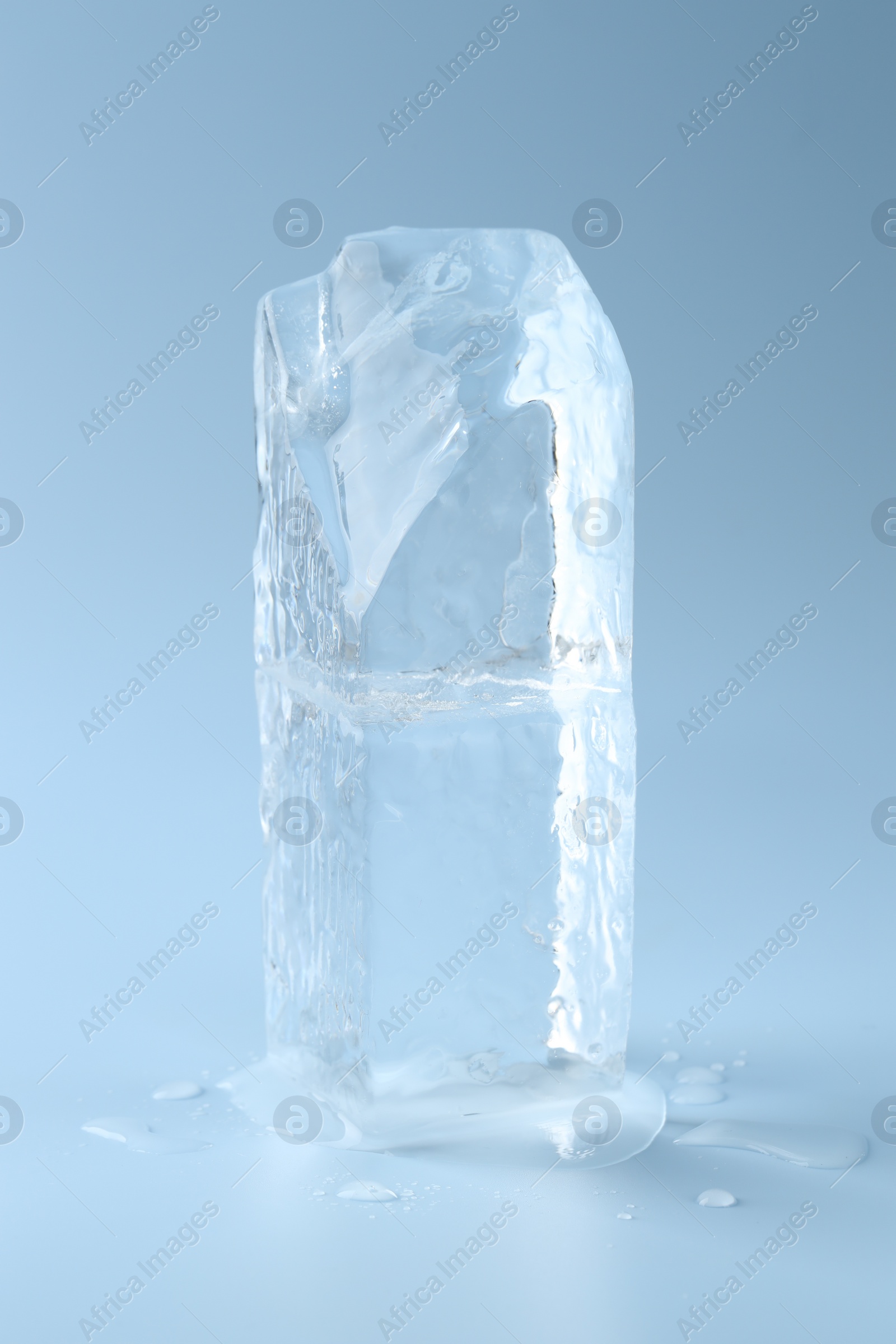 Photo of Blocks of clear ice on light blue background