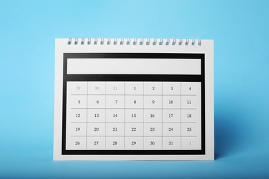 Paper calendar on light blue background. Planning concept