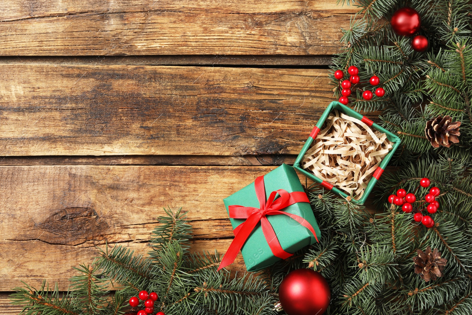 Photo of Flat lay composition with Christmas gift box on wooden table. Space for text