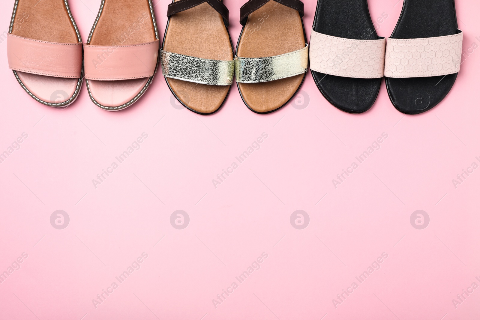 Photo of New trendy women's shoes on color background, top view