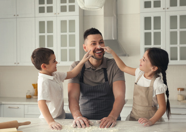 Photo of Happy family cooking together in kitchen at home