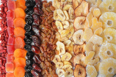Photo of Different tasty dried fruits as background, top view