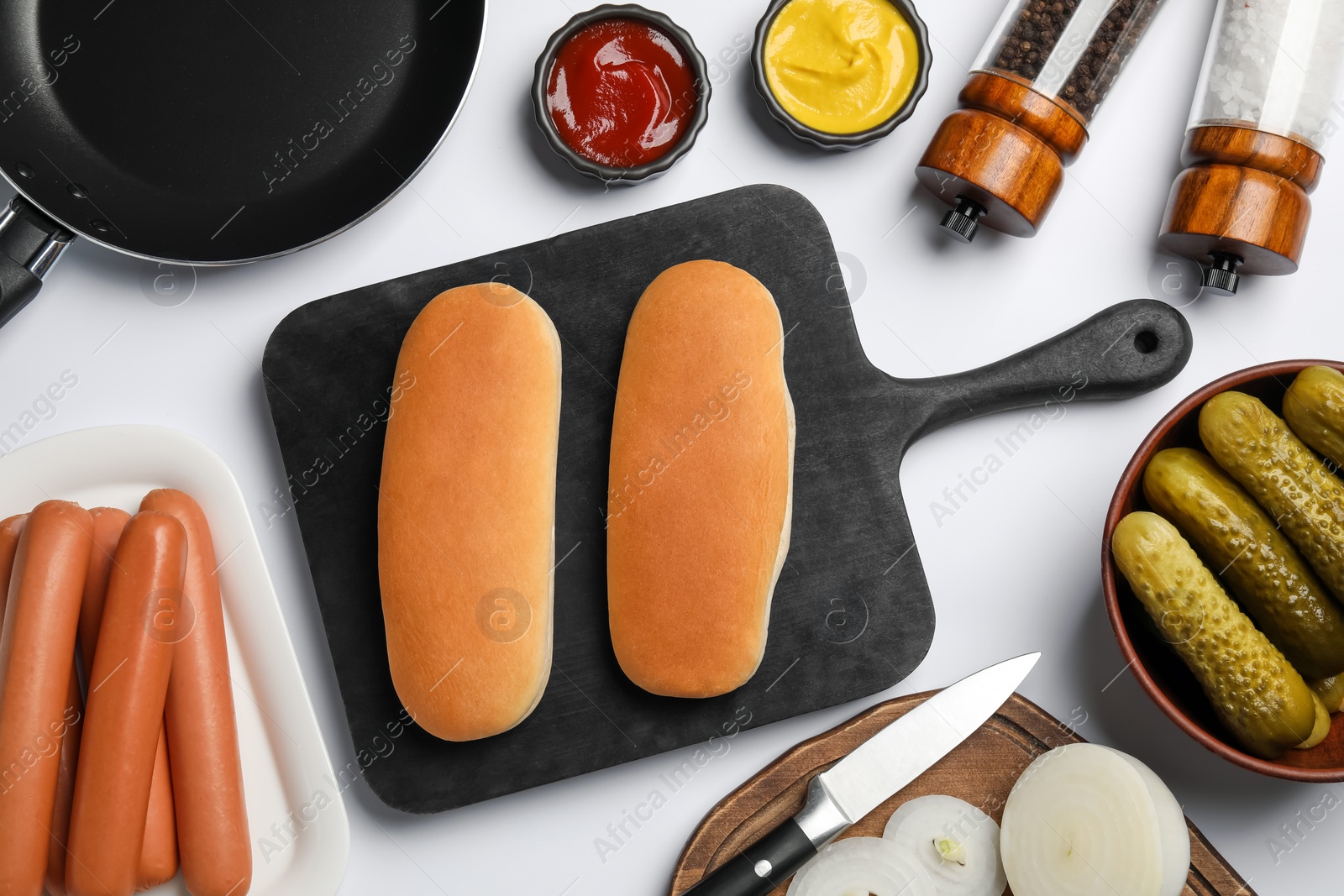 Photo of Different tasty ingredients for hot dog on white table, flat lay