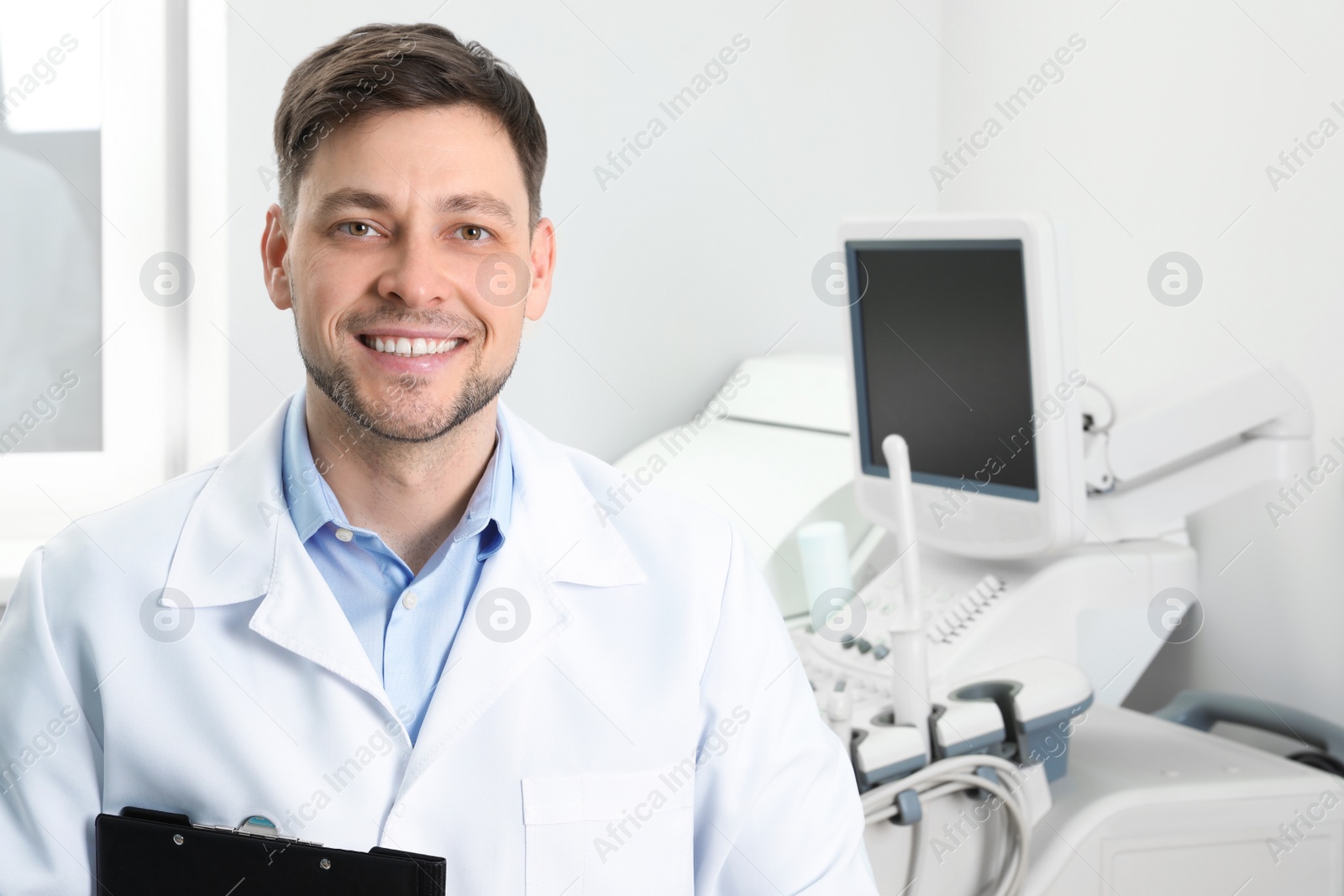 Photo of Professional sonographer near modern ultrasound machine in clinic