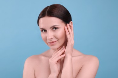 Photo of Beautiful woman with healthy skin on light blue background. Body Care