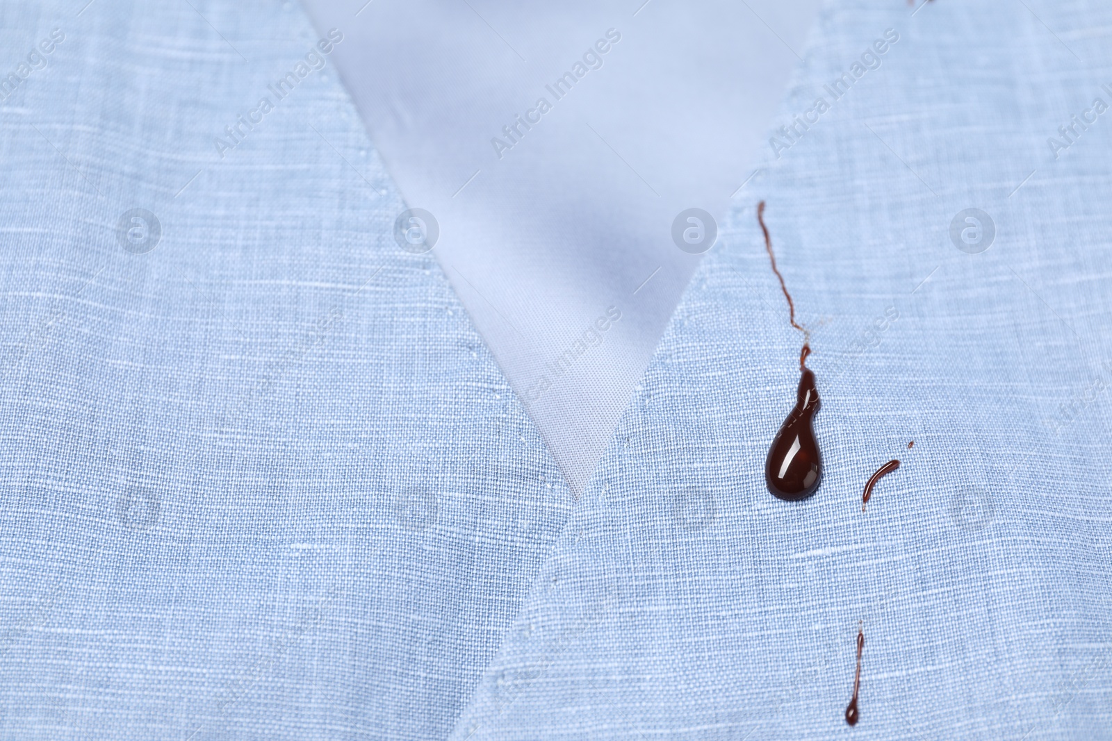 Photo of Dirty vest with drops of chocolate, closeup view