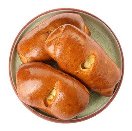 Plate with delicious baked patties on white background, top view