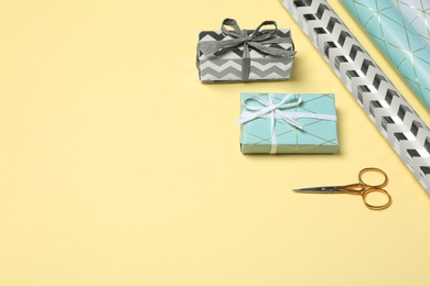 Photo of Beautiful gift boxes and tools for decor on color background. Space for text