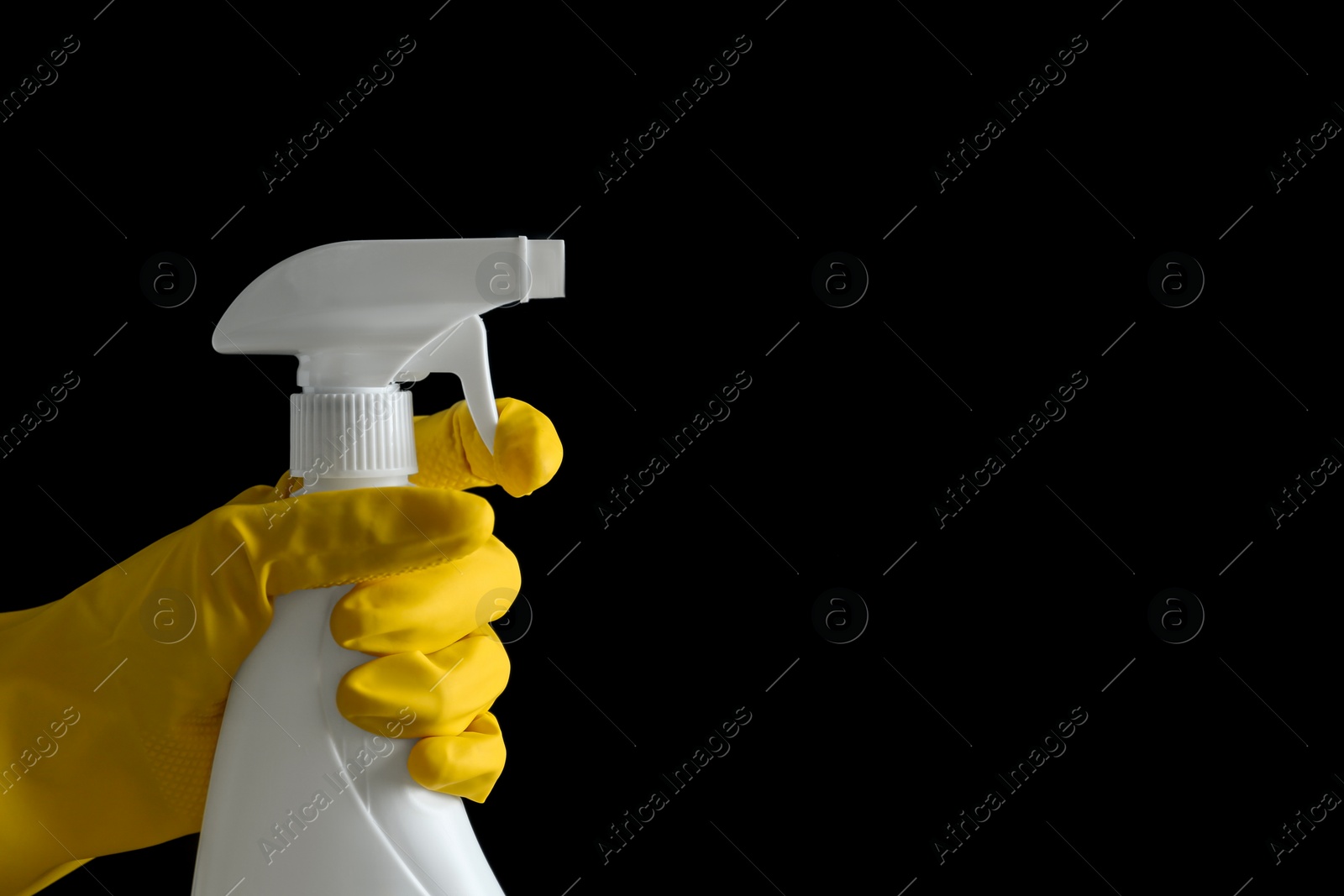 Photo of Person in gloves spraying detergent on black background, closeup. Space for text