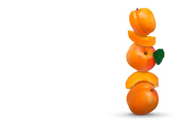 Stack of fresh ripe apricots on white background