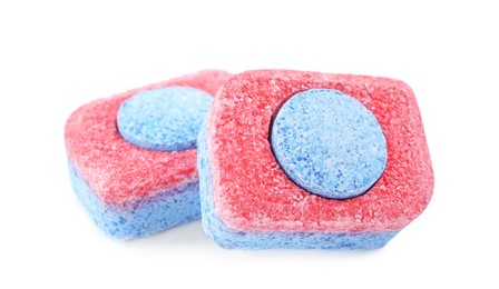 Photo of Two dishwasher detergent tablets on white background, closeup