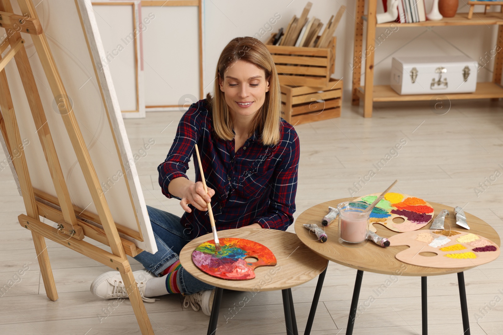 Photo of Beautiful woman painting in studio. Creative hobby