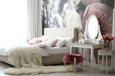 Photo of Stylish bedroom interior with elegant dressing table and floral wallpaper