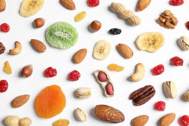 Flat lay composition of different dried fruits and nuts on white background