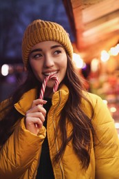 Photo of Young woman spending time at Christmas fair