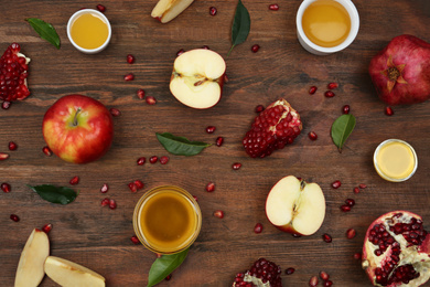 Photo of Flat lay composition with honey and fruits on wooden table. Rosh Hashanah holiday