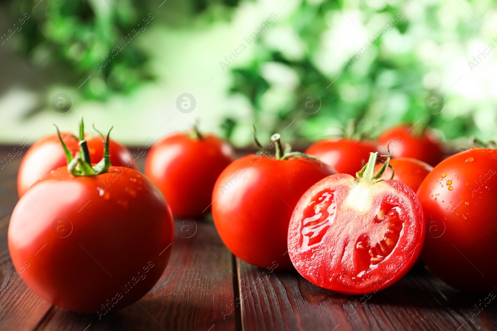 Photo of Fresh ripe red tomatoes on wooden table