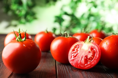 Fresh ripe red tomatoes on wooden table