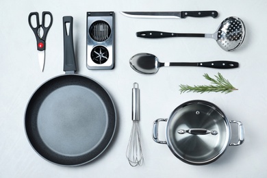 Photo of Flat lay composition with clean cookware on light background