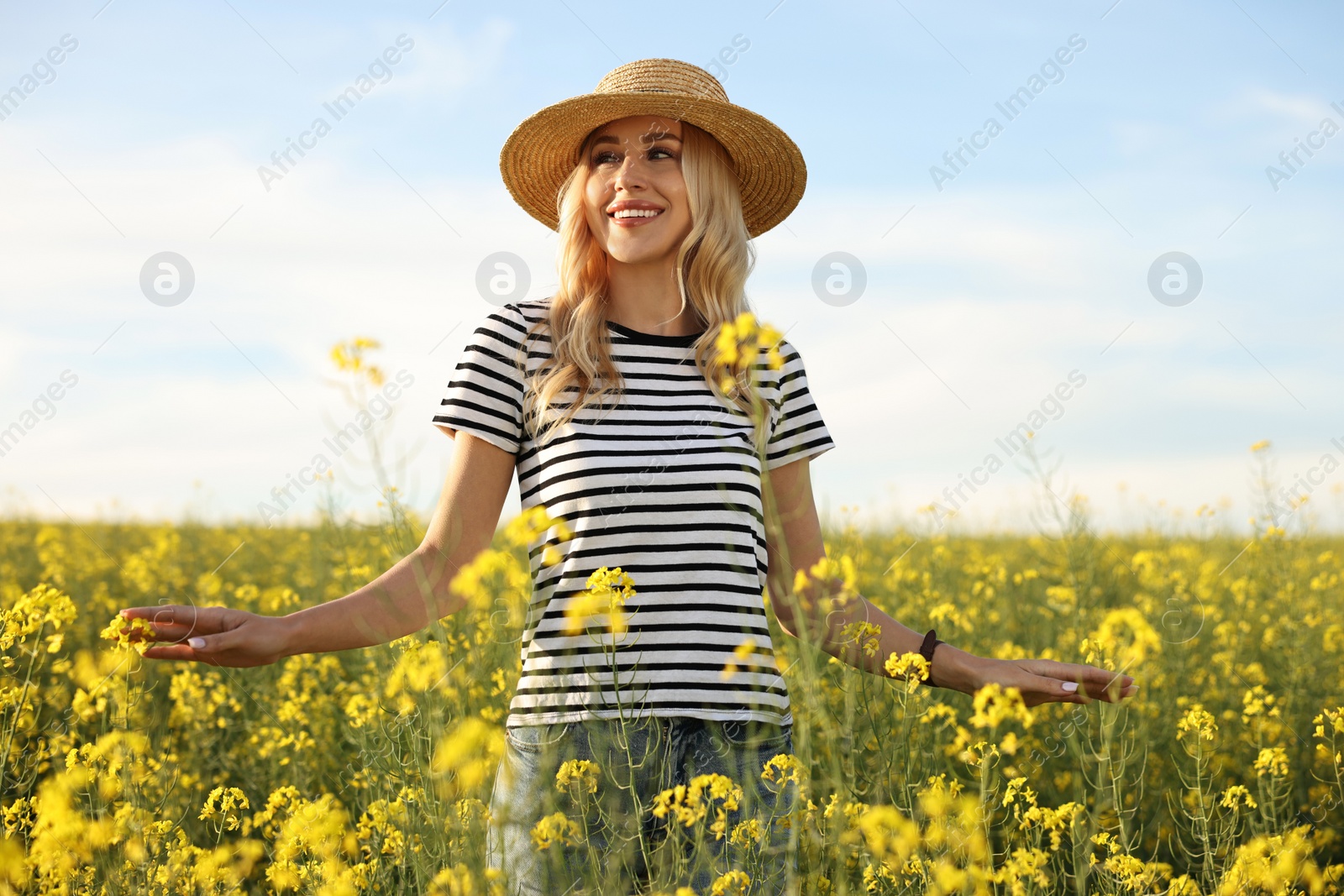 Photo of Happy young woman with straw hat in field on spring day