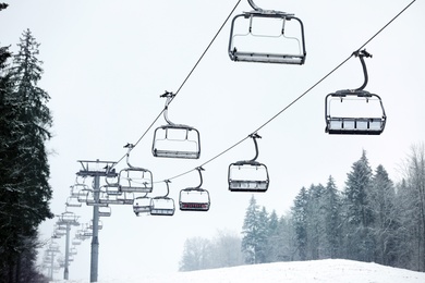 Photo of Ski lift at mountain resort. Winter vacation