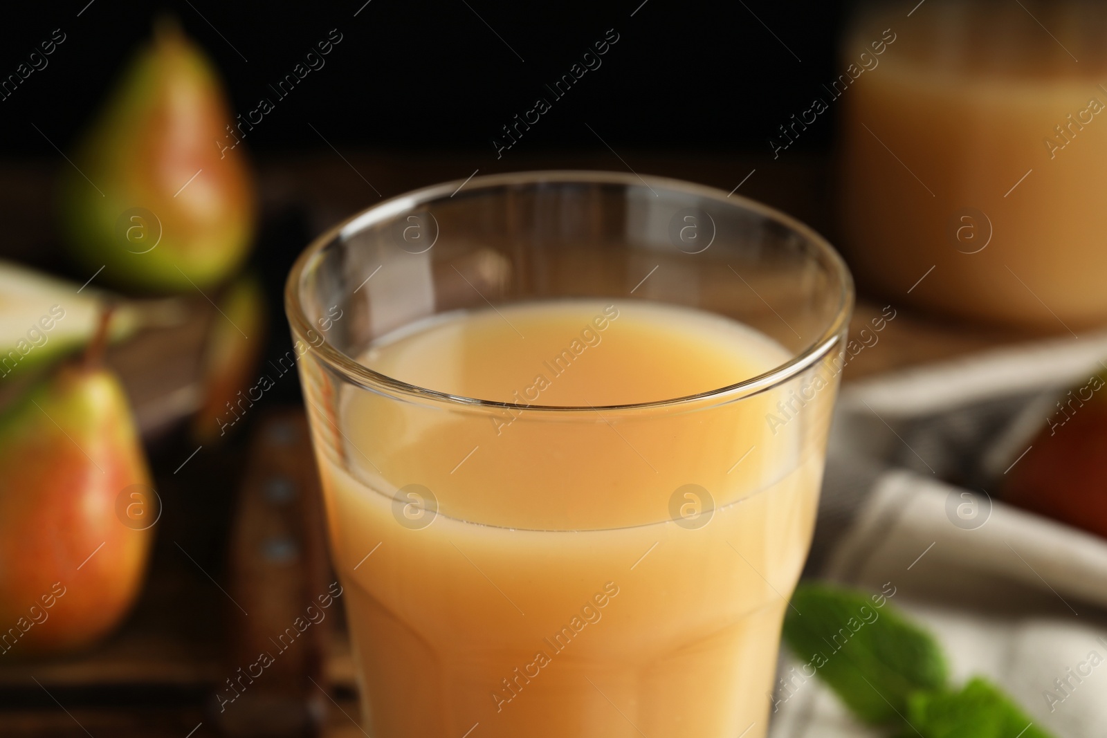 Photo of Fresh pear juice in glass, closeup view