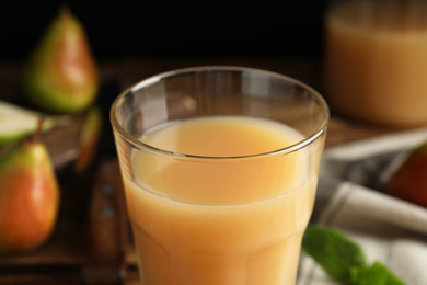 Photo of Fresh pear juice in glass, closeup view