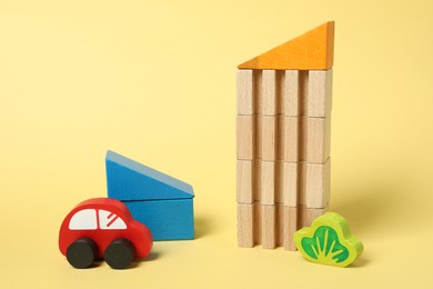 Photo of Set of wooden toys on yellow background. Children's development