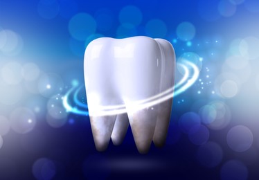 Image of Tooth model with glowing on blue background, bokeh effect. Dental care